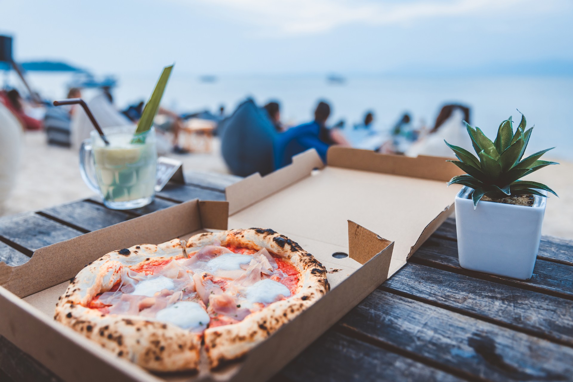 Italian Pizza Margherita with parma ham and mozzarella cheese in box at beach club Thailand